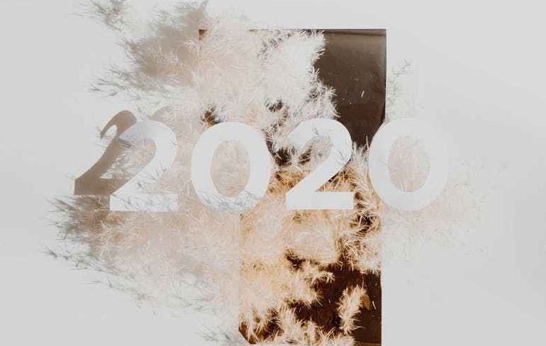 Abstract white and brown painting with "2020" over it.